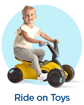 Toddler riding a yellow push car with handlebars and footrests.